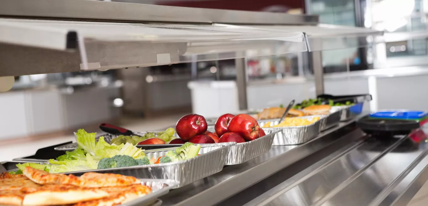 Trays of food in school cafeteria.