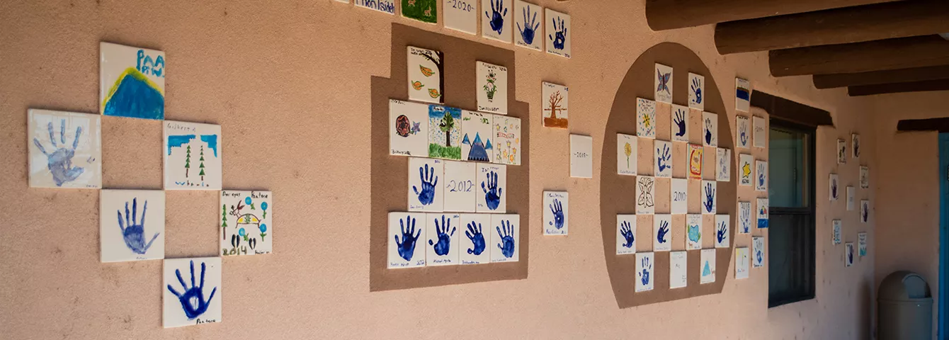 Artwork displayed on exterior wall of School building.