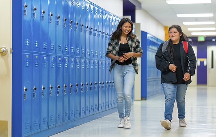 Students walking in the hall of school. 